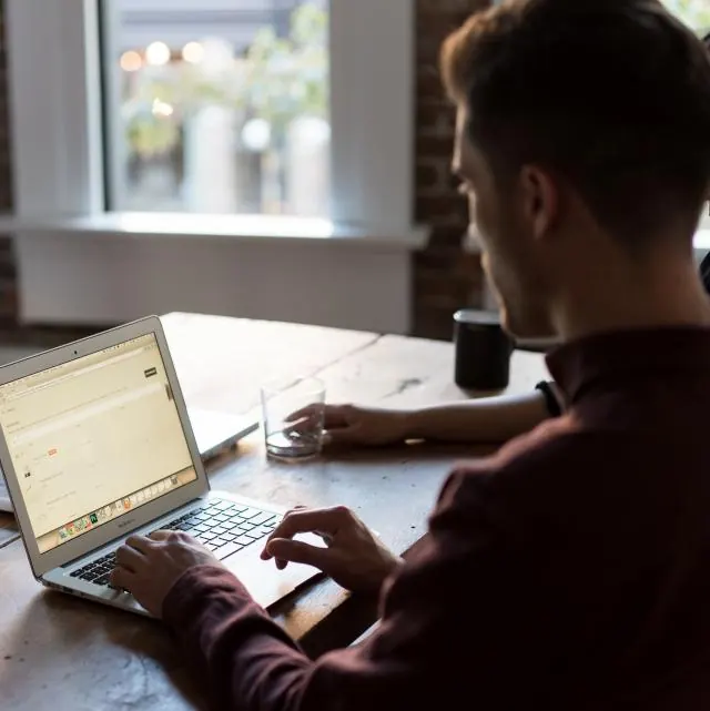 Bookkeeper working through accounts on a laptop